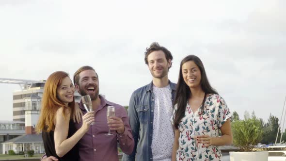 Group of friends celebrating with champagne outdoors