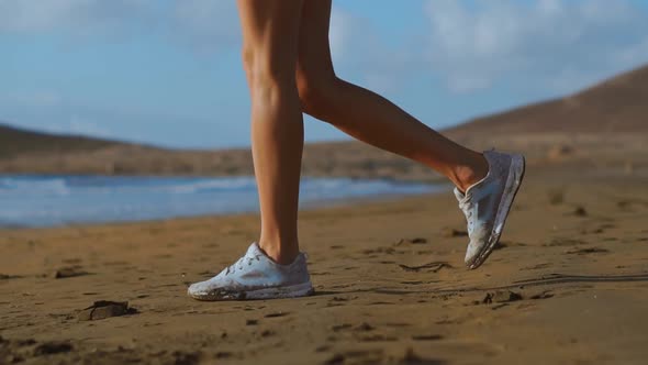 Close-up Shot of a Woman in White Sneakers Walking on Beach, Beautiful White Sand. SLOW MOTION