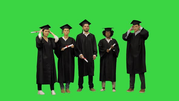 Graduation Students Listening to the Instructions Getting Ready for the Group Picture on a Green