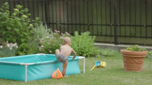 Toddler Boy Child Getting Out Blue Water Pool in Garden Summer Day Running