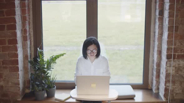 Asian Woman Working Alone