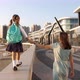 Young mother with little daughter in uniform going to school at morning - VideoHive Item for Sale