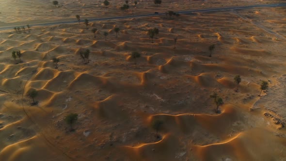 Aerial view above of dunes during scenic sunset, U.A.E.