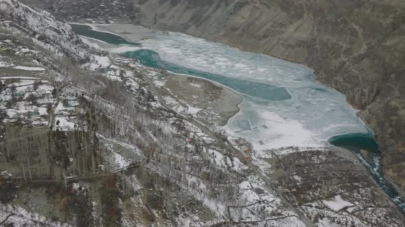 Cinematic Aerial View Of Frozen Khalti Lake In Gupis-Yasin Valley. Dolly Back, Circle Dolly