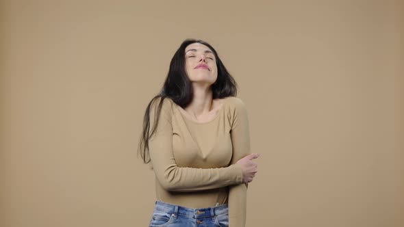 Portrait of a Model with Natural Beauty Coquettishly Looking at Camera and Smiling