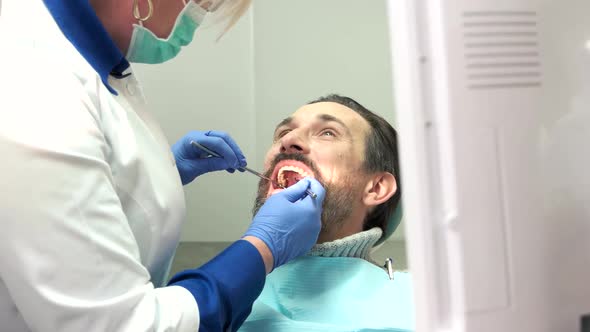 Dentist Working with Patient.
