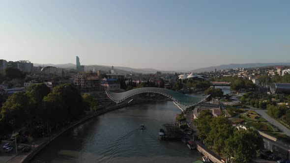 Aerial Shooting of the City Center of Tbilisi in Georgia, Peace Bridge, The Camera Flies a Radius