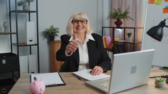 Senior Business Woman Raises Thumbs Up Agrees Approve Likes Good News Using Laptop at Home Office