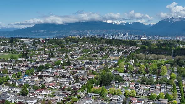 Aerial View Of Neighborhood In Oakridge, Vancouver, Canada. Cityscape And Mountain Landscape In Back