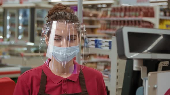 Portrait Of Young Cashier In Face Shield