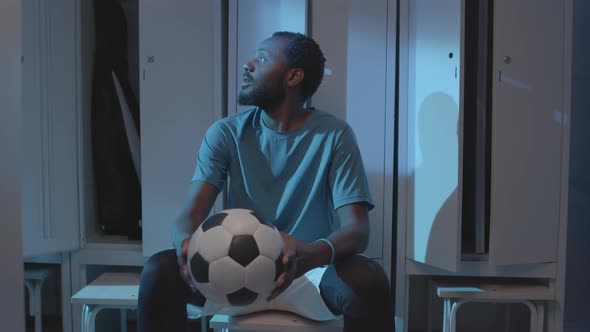 Soccer Player Waiting in Locker Room