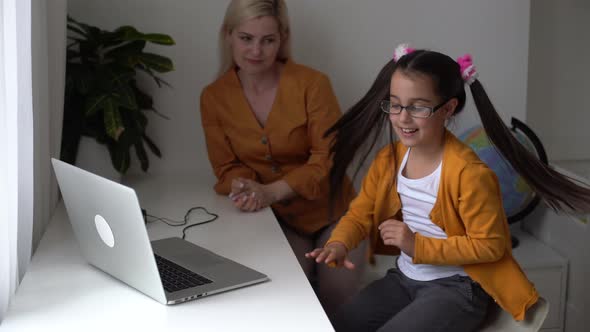 Crazy Little Daughter Prevents and Disturbing Tired Mother Holding Hands on Head While Working on