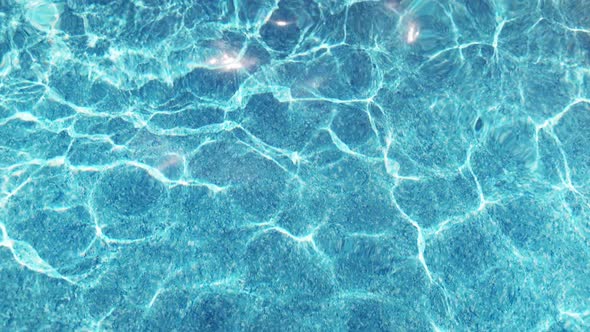 The Clear Water in the Pool Gleams and Reflects the Rays of the Sun on a Summer Day