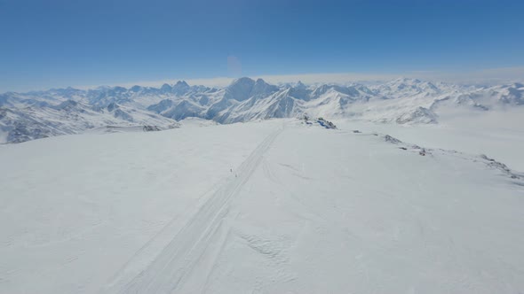 Aerial View Snowboarding Track of Snow Mountain Slope at Natural Landscape Clear Blue Sky