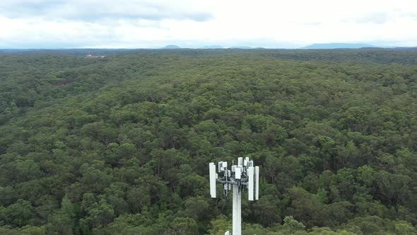 Aerial footage of a telecommunications tower from top to bottom