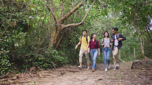 Group of young Asian man and woman friend feeling fresh and relax to travel in the forest together