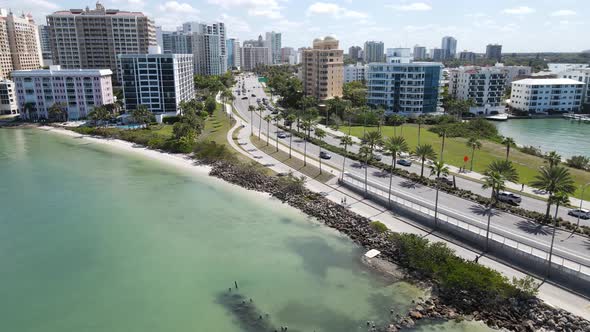 Aerial drone flight to the start of Gulf Stream drive after exiting John Ringling Causeway in beauti