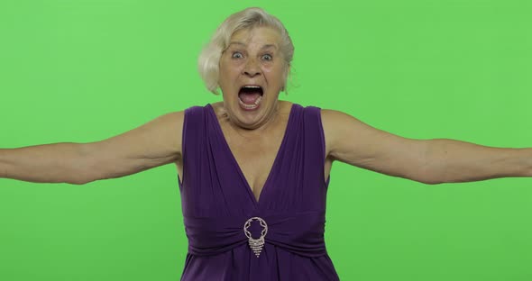 An Elderly Woman Shows Amazement, Joy and Smiles. Old Grandmother. Chroma Key