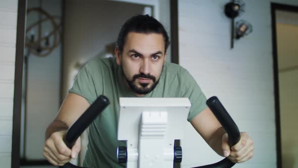 Fitness man on a bicycle doing spinning at the gym. 