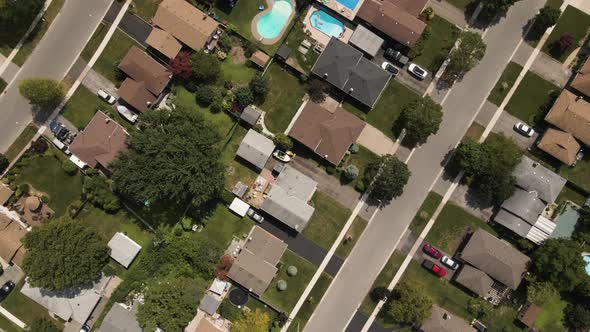 Aerial birds eye shot of Suburban Neighborhood in Welland with road and cars during sunny day - Cana