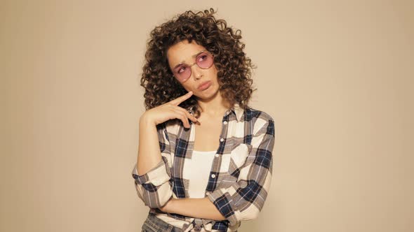 Beautiful smiling model with afro curls hairstyle dressed in hipster clothes