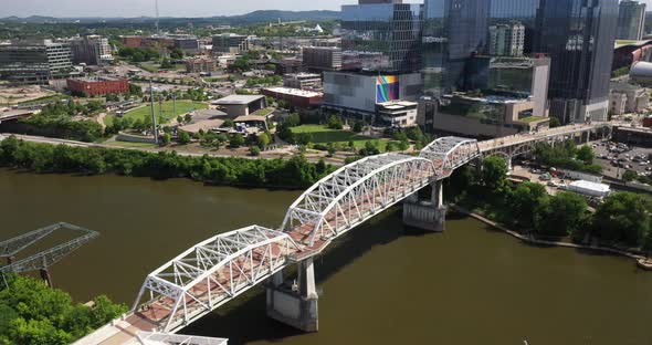 Pedestrian bridge in Nashville, Tennessee with drone video moving down.