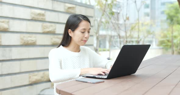 Woman use of notebook computer at outdoor