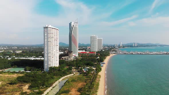 Aerial view of Pattaya Thailand tall buildings on beach in the afternoon.