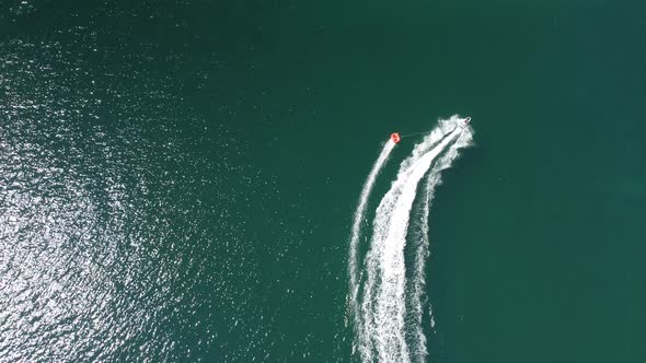 Happy People Swim on Air Mattress Behind a High Speed Water Bike