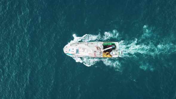 Top view of a fishing ship that floats on the waves.