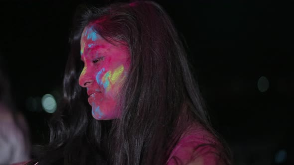 Dancing Young Indian Woman with Dry Color Powder Holi Exploding Around Her
