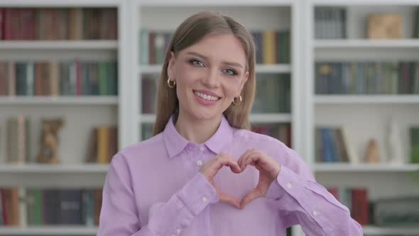 Portrait of Woman Showing Heart Shape By Hands