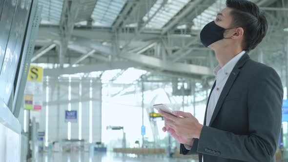 asian business people wear mask face protection business travel checking map and flight schedule