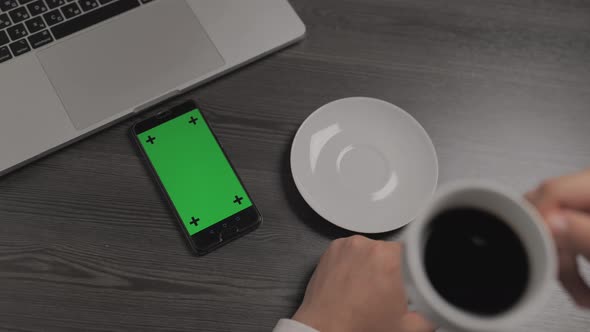 Mobile Phone with Green Screen Chroma Key Laying Near on the Table