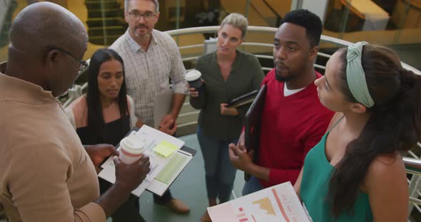 Portrait of happy diverse male and female business colleagues with documents