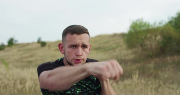 Strong Boxers Training Kicks on Nature at Camera