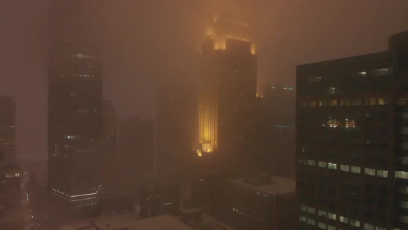 buildings in downtown during a snowstorm at night