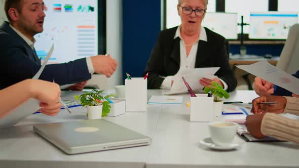 Confident Company Manager Giving Working Tasks to Diverse Teamworkers