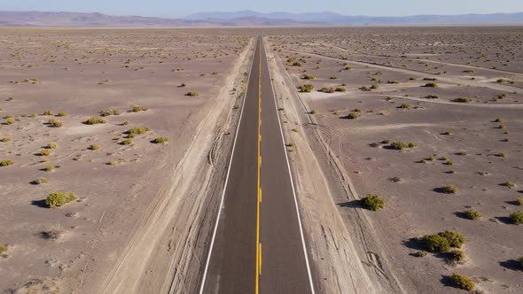 Aerial shot of a remote desert road with no cars in Nevada