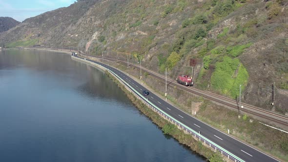 Freight Locomotive Train Driving Down a River Valley