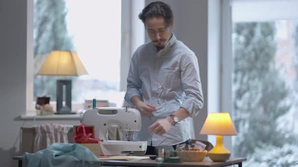 Portrait of Thoughtful Talented Creative Male Tailor Standing in Workshop Thinking