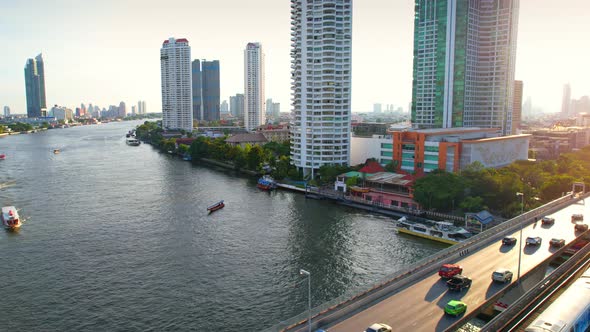 4K : Drones fly over the Chao Phraya River, buildings and business districts in Bangkok