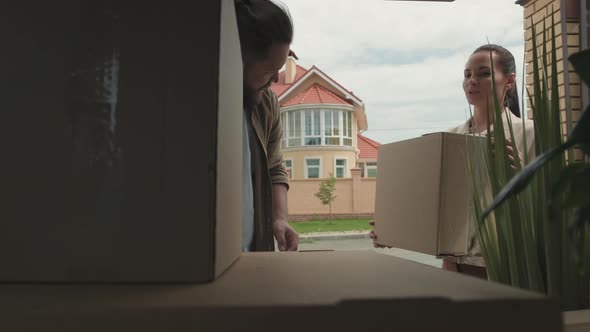 Couple Packing Car and Moving House