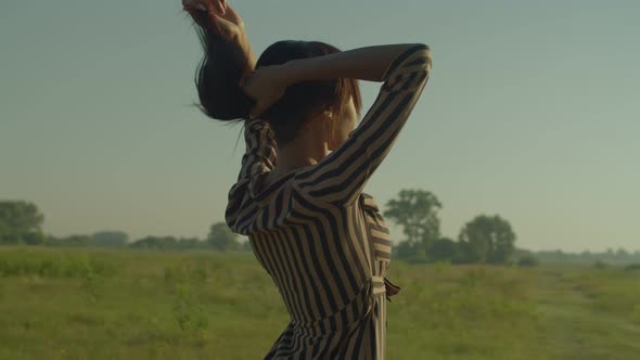 Relaxed Pretty Black Female Enjoying Leisure in Summer Nature at Dawn