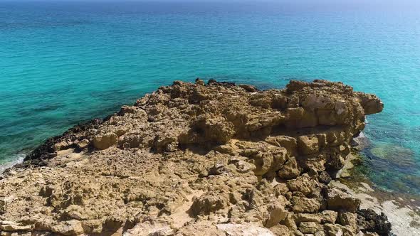 Aerial Landscape at the Edge of the Earth Turquoise Calm Sea Waves Beat Against a Rocky Cliff Ocean