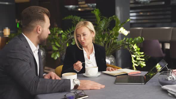 Business Colleagues Have Conversation and Talking at Meeting in Restaurant