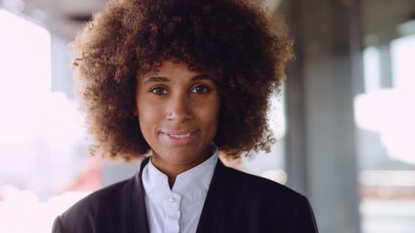 Businesswoman With Afro Hair Smiling To Camera