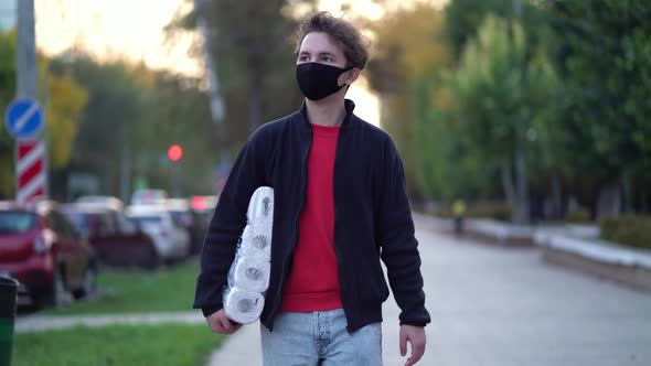 Teen Walking in Medical Mask with Toilet Paper During the Second Wave Quarantine Coronavirus COVID