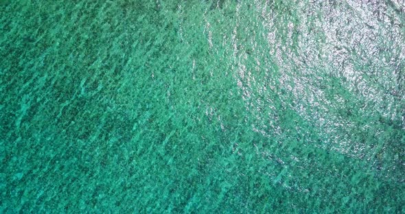 Tropical birds eye island view of a sandy white paradise beach and blue water background in hi res 4