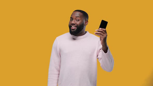 Excited Afro-American Man Holding Smartphone and Dollars, Online Money Transfer, Purchase Easy